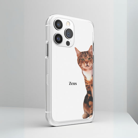 Custom Cat Phone Case featuring a portrait of Zeus the cat for iPhone, displayed under the light on a simple contemporary white table.