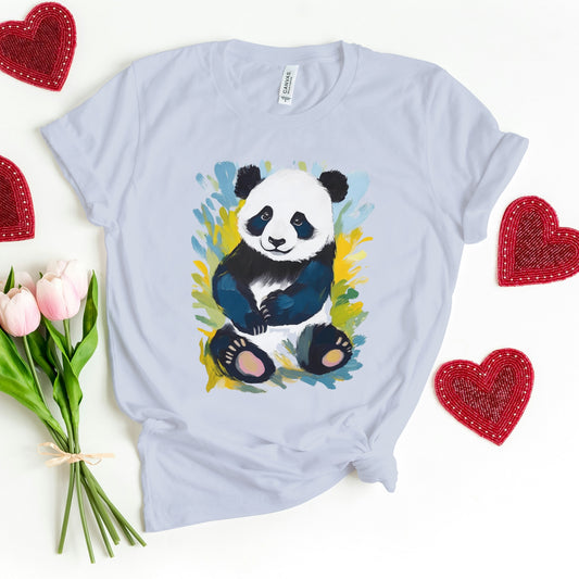 Light blue cotton t-shirt featuring a cute panda surrounded by artistic brushstrokes of vibrant nature, naturally complemented by a blooming flower next to it.