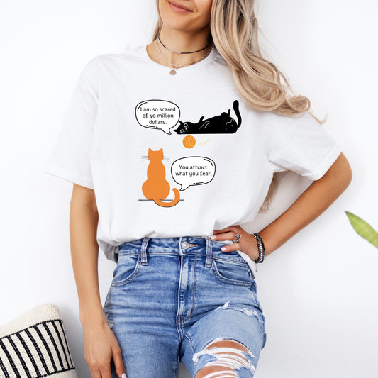 A woman wearing a white cotton funny cat shirt featuring an amusing cat graphic with witty speech.