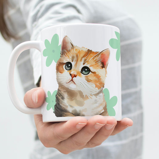A woman extending her hand with a warm gesture, offering a white glossy ceramic mug adorned with an adorable watercolor-style cat illustration and a charming clover pattern design.