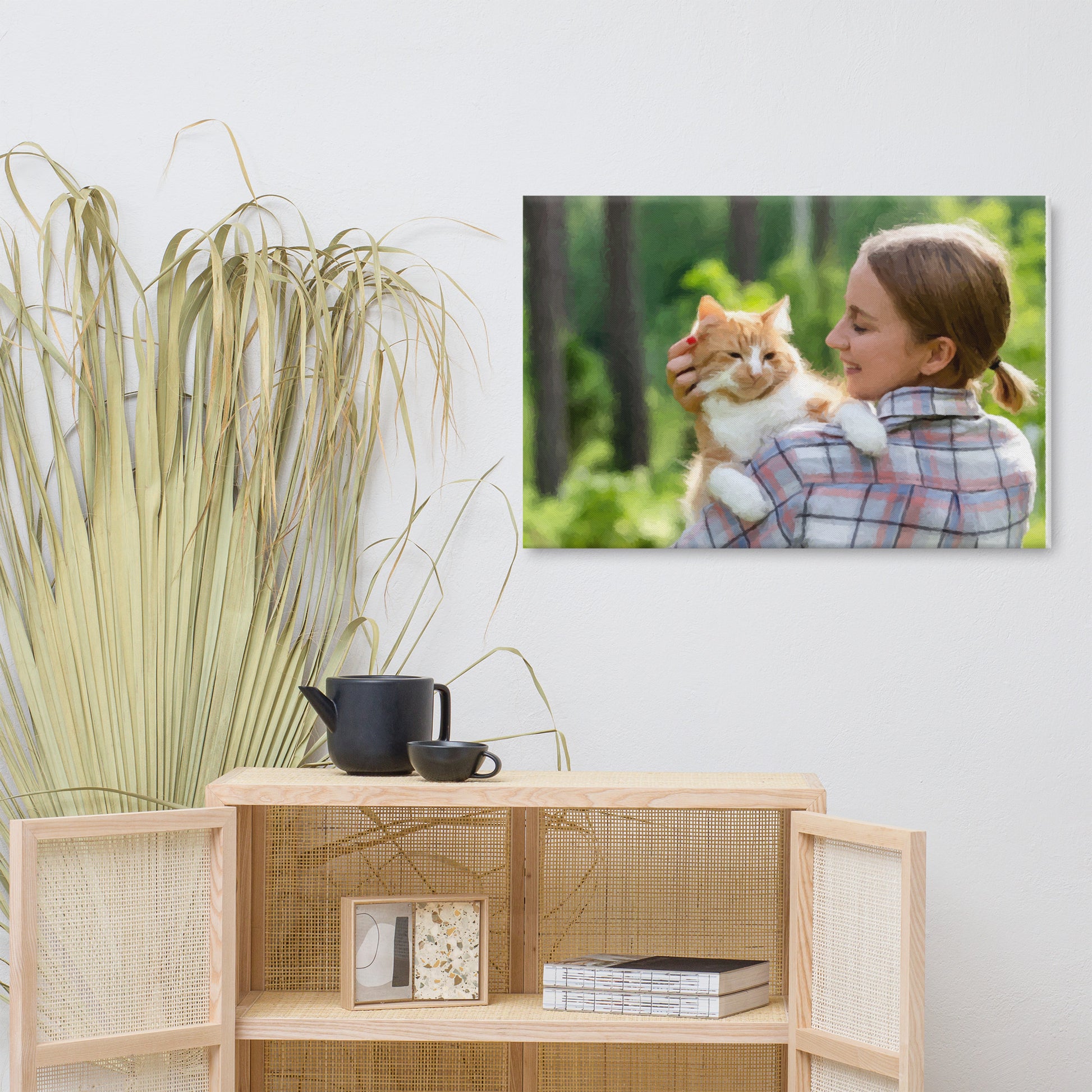 Pet and owner portraits featuring a woman holding her cat on a canvas displayed on a wall