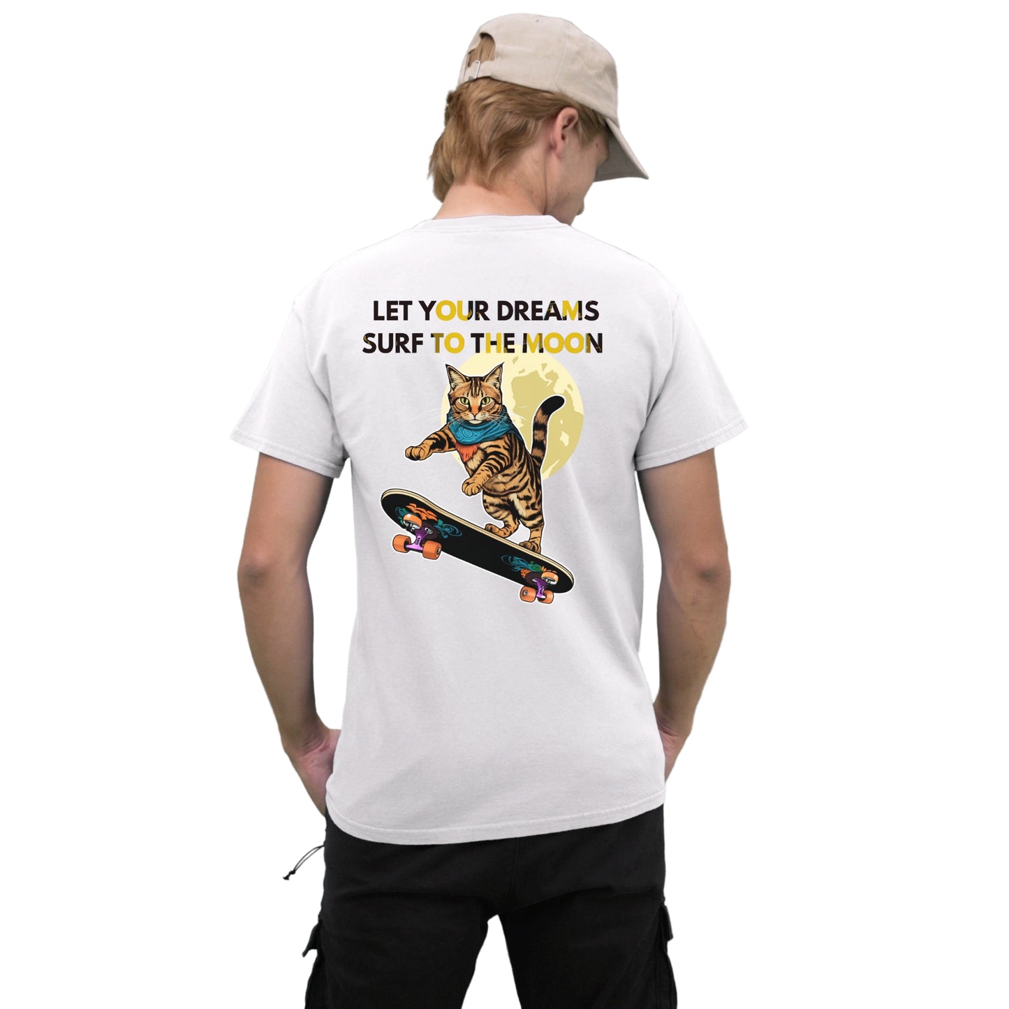 Back view of a young man wearing a white cotton T-shirt with a cat skateboarding toward the moon graphic, posing for a photo.