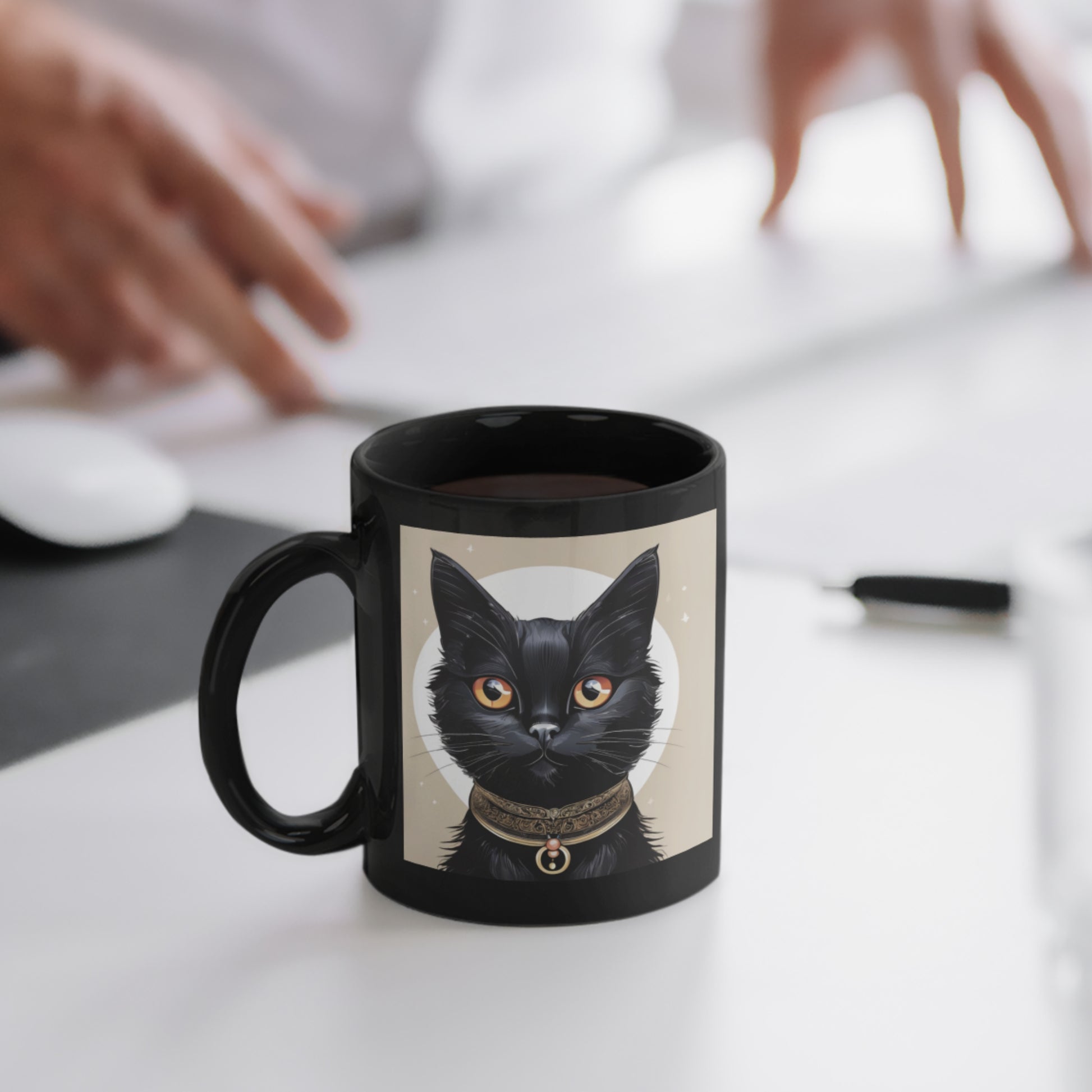 A sleek black coffee mug with a whimsical black cat illustration on one side, resting on an office table.