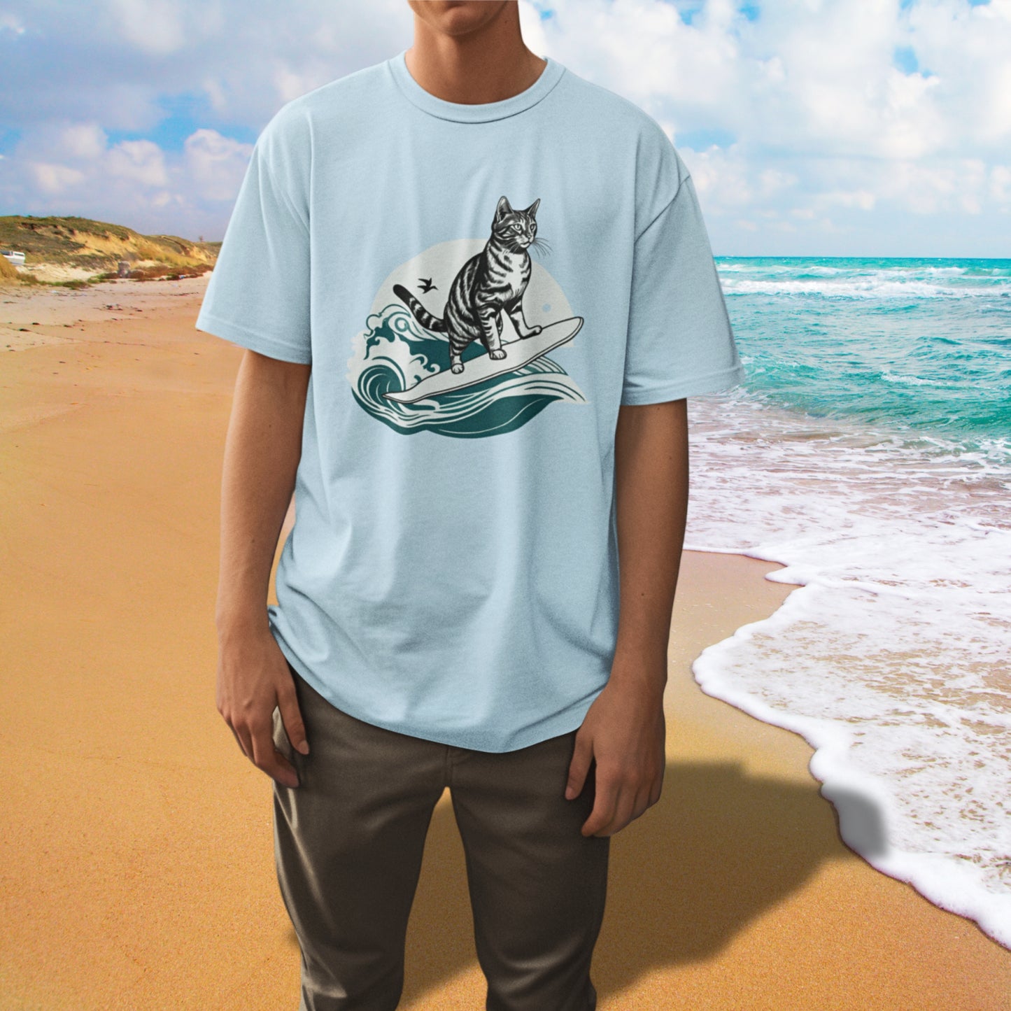 Man wearing a light blue T-shirt with a surfing cat design, looking stylish and cool.