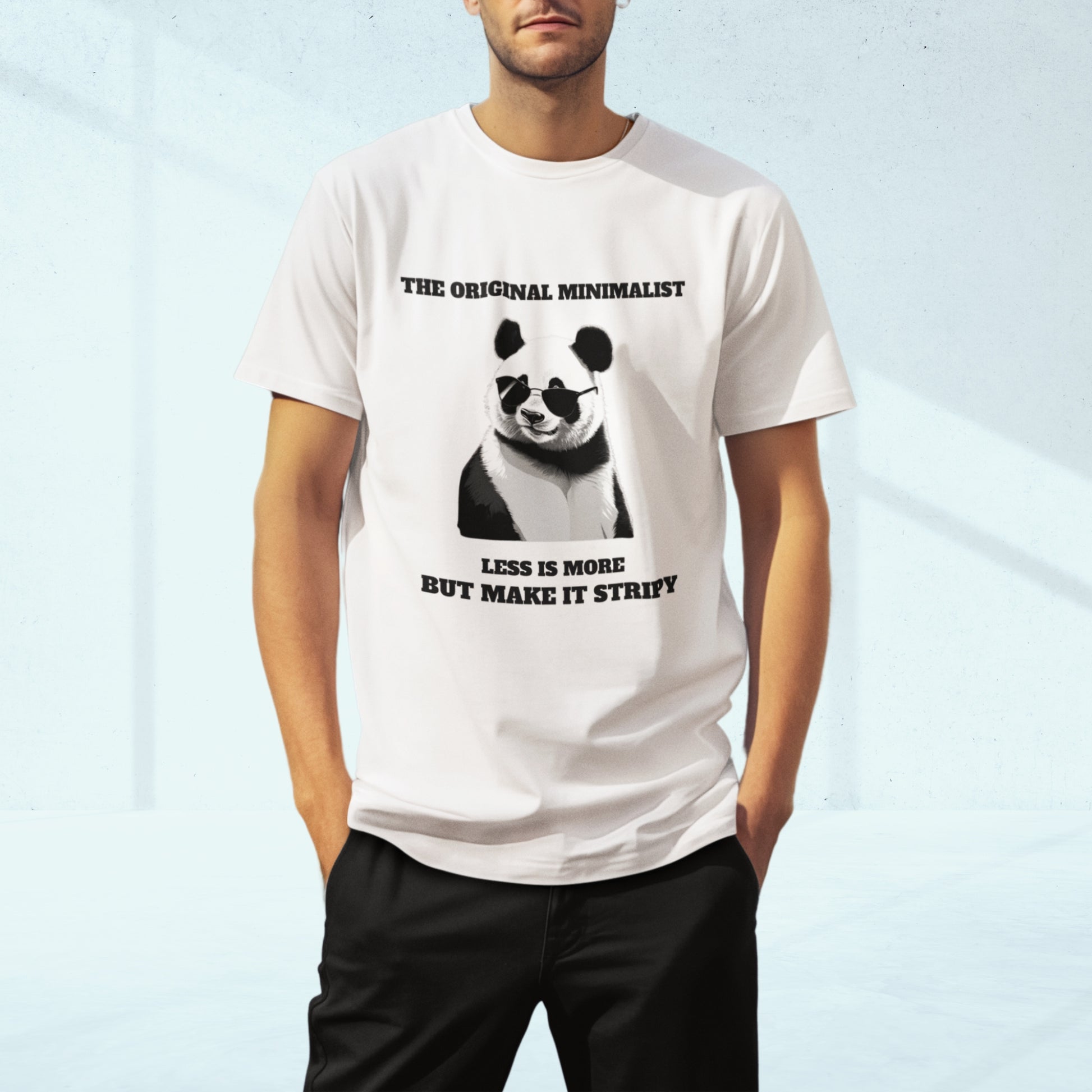 Man wearing white minimalist panda graphic tee with sunglasses and quote: 'THE ORIGINAL MINIMALIST, LESS IS MORE, BUT MAKE IT STRIPY.' Soft cotton unisex humor t-shirt.