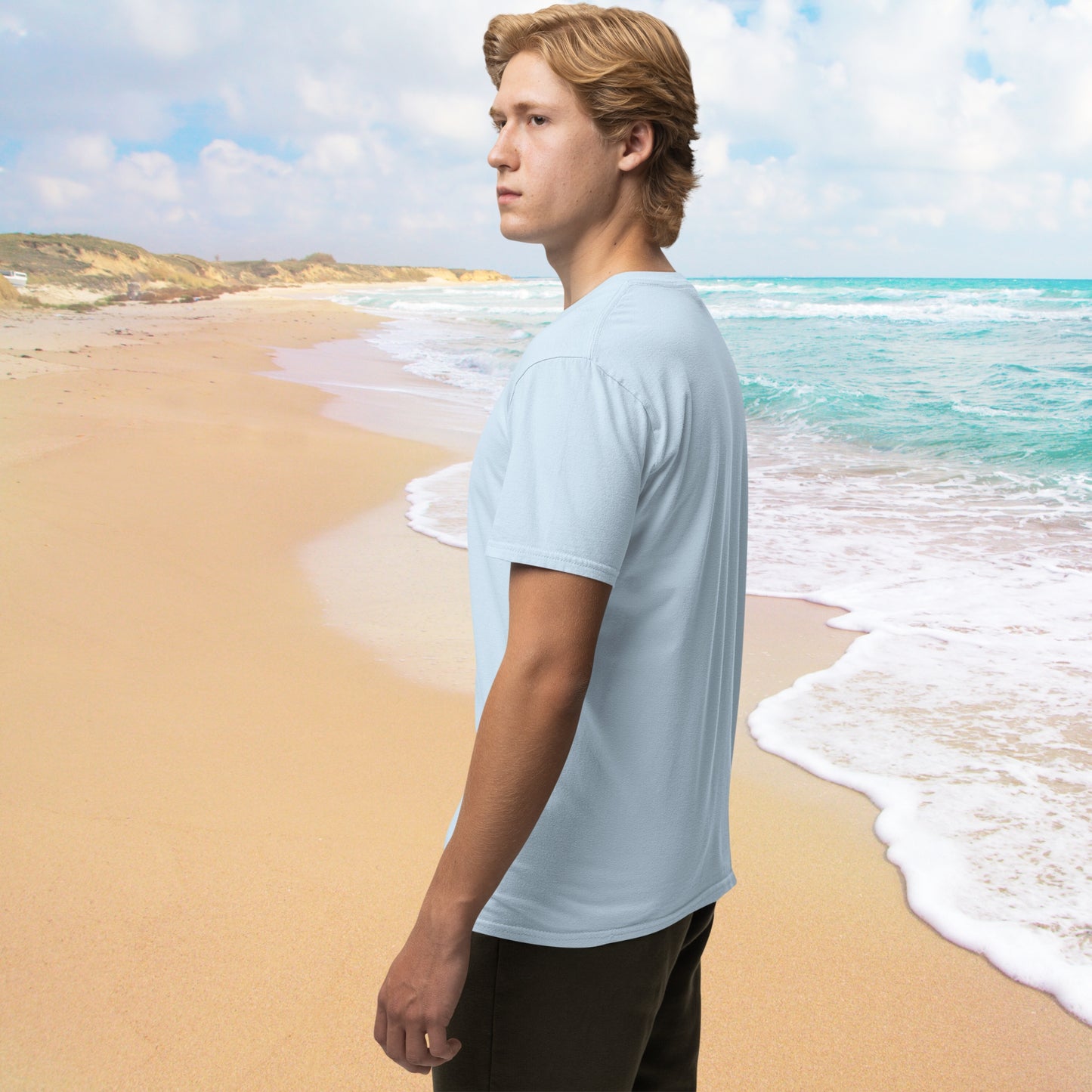 A side view of a young man wearing a casual, short-sleeved light blue cotton t-shirt, appearing relaxed and effortlessly stylish.