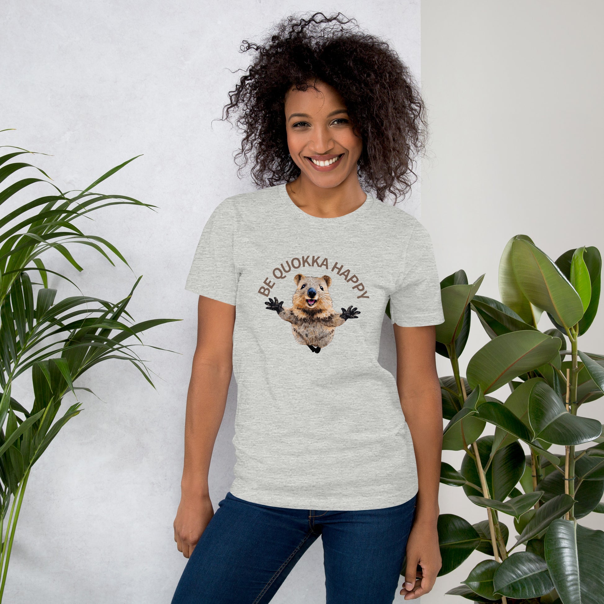 A woman wearing a grey cotton T-shirt with a Happy Quokka graphic.