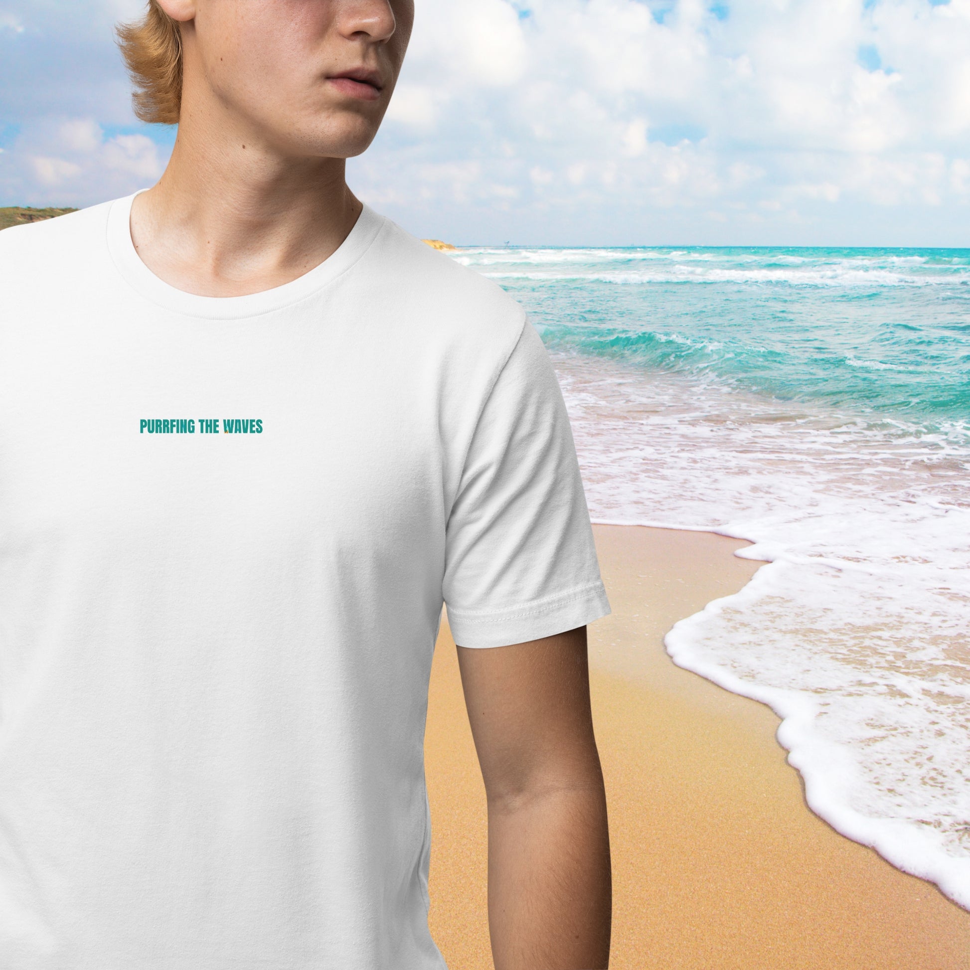A young man wearing a white funny cat tee shirt, featuring the playful text: 'Purrrfing the Waves' printed on it. A cool and humorous design for cat lovers!